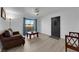 Living room featuring wood-look floors, modern fan, comfortable seating, and natural light at 5241 Janfred Ct # 26, Las Vegas, NV 89103