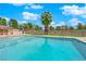 Community swimming pool featuring a palm tree, fencing, and manicured landscaping at 5241 Janfred Ct # 26, Las Vegas, NV 89103