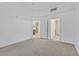 Spacious bedroom with neutral carpet and doorway to kitchen at 59 E Agate Ave # 406, Las Vegas, NV 89123