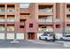 Condominium building exterior displaying unit entrances and covered parking spaces at 59 E Agate Ave # 406, Las Vegas, NV 89123
