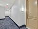 Well-lit hallway with neutral decor leading to unit 406 at 59 E Agate Ave # 406, Las Vegas, NV 89123