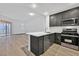 Open-concept kitchen with stainless appliances and a view of the outdoor patio at 59 E Agate Ave # 406, Las Vegas, NV 89123