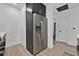 View of stainless steel refrigerator and stone countertops with open doorway to adjacent room at 59 E Agate Ave # 406, Las Vegas, NV 89123