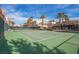 Well-maintained tennis court surrounded by lush greenery and mature trees at 59 E Agate Ave # 406, Las Vegas, NV 89123