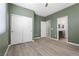 Spacious bedroom with wood-look floors, a large window, and a double door closet at 5918 Peridot Falls Ave, Las Vegas, NV 89130