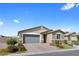 Single-story home featuring a two-car garage, neutral stucco, and low maintenance landscaping at 5918 Peridot Falls Ave, Las Vegas, NV 89130