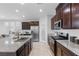 Bright kitchen with stainless steel appliances, an island with seating, and ample cabinet space at 5918 Peridot Falls Ave, Las Vegas, NV 89130