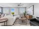 Bright living room with a comfortable sofa, stylish decor, and a ceiling fan at 5918 Peridot Falls Ave, Las Vegas, NV 89130