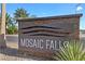 Decorative stone sign for Mosaic Falls community under a sunny, blue sky at 5918 Peridot Falls Ave, Las Vegas, NV 89130