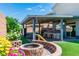 The backyard is the perfect outdoor living space with fire pit, BBQ area, bar seating and hot tub at 5976 Rockway Glen Ave, Las Vegas, NV 89141