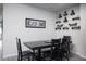 Clean dining room with four chairs and decorated shelving at 5976 Rockway Glen Ave, Las Vegas, NV 89141