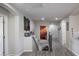 A hallway leads to the staircase, which goes down to the basement, and is lined with decorations at 5976 Rockway Glen Ave, Las Vegas, NV 89141