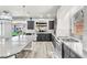 Bright kitchen featuring a large island, stainless steel appliances, and access to the backyard at 5976 Rockway Glen Ave, Las Vegas, NV 89141