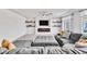 Inviting living room with a cozy fireplace, a large gray sectional, and built-in shelving at 5976 Rockway Glen Ave, Las Vegas, NV 89141