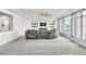 Expansive living room boasts a wide sectional and sunlit windows, offering comfort and light at 5976 Rockway Glen Ave, Las Vegas, NV 89141