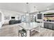Open-concept layout showcasing a kitchen island and seamless flow to the living area with hardwood flooring at 5976 Rockway Glen Ave, Las Vegas, NV 89141