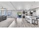 Open-concept living space with a kitchen island, hardwood floors, and a view of the living room at 5976 Rockway Glen Ave, Las Vegas, NV 89141