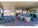 Outdoor kitchen features stainless steel appliances, stone accents, tiled countertop, and built-in beverage fridge at 5976 Rockway Glen Ave, Las Vegas, NV 89141