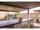 Outdoor kitchen features stainless steel appliances, stone accents, tiled countertop, and a built-in beverage fridge at 5976 Rockway Glen Ave, Las Vegas, NV 89141