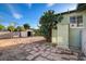 Spacious backyard featuring a detached storage shed, brick pavers, and mature landscaping at 709 New Mexico St, Boulder City, NV 89005