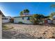 Lawn offers a large backyard with grass, mature trees, and brick-paved accents at 709 New Mexico St, Boulder City, NV 89005