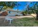 Grassy backyard with mature trees, outdoor seating, and plenty of space to relax at 709 New Mexico St, Boulder City, NV 89005
