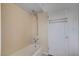 Bathroom featuring bath and shower with neutral tile and door at 709 New Mexico St, Boulder City, NV 89005