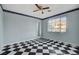 Light-blue bedroom with checkered floor, ceiling fan, and natural light at 709 New Mexico St, Boulder City, NV 89005