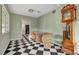 Cozy dining area with black-and-white flooring, classic furnishings, and a vintage grandfather clock at 709 New Mexico St, Boulder City, NV 89005
