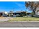 Charming single-story home featuring a well-maintained lawn, covered carport, and mature landscaping at 709 New Mexico St, Boulder City, NV 89005