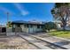 View of house with covered parking, updated landscaping, and hardscaped driveway at 709 New Mexico St, Boulder City, NV 89005