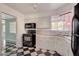 Spacious kitchen featuring granite countertops and black-and-white flooring at 709 New Mexico St, Boulder City, NV 89005