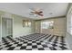 Sunlit living room boasting built-in shelving, black and white tile flooring, and a stylish ceiling fan at 709 New Mexico St, Boulder City, NV 89005