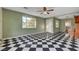Spacious living room boasts a distinctive black-and-white tile floor and large picture windows at 709 New Mexico St, Boulder City, NV 89005