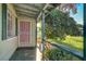 Covered front porch with awning, landscaping, and mature trees creating an inviting entrance at 709 New Mexico St, Boulder City, NV 89005