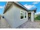 Backyard area featuring a brick patio, stucco exterior, and neatly landscaped greenery at 712 Webber Park St, Henderson, NV 89011