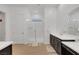 Bathroom with double sinks, spacious walk-in shower and dark wood cabinets at 712 Webber Park St, Henderson, NV 89011