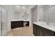 Bright bathroom features double sinks, dark wood cabinets, and glass shower at 712 Webber Park St, Henderson, NV 89011