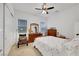 Bright bedroom with hardwood floors, a large dresser, and a view of the backyard at 712 Webber Park St, Henderson, NV 89011