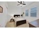 Comfortable bedroom features neutral colors, a ceiling fan, and two windows for natural light at 712 Webber Park St, Henderson, NV 89011