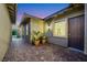 Inviting courtyard with brick pavers and mature potted plants, creating a cozy outdoor space at 712 Webber Park St, Henderson, NV 89011