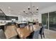 Open-concept dining area with a wooden table, chandelier, and access to the kitchen and outdoor patio at 712 Webber Park St, Henderson, NV 89011