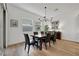 Dining room featuring an ornate light fixture and a dark wood dining set at 712 Webber Park St, Henderson, NV 89011