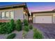 Attractive single-story home featuring a brick-accented facade and lush landscaping at 712 Webber Park St, Henderson, NV 89011