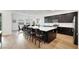 Open kitchen with dark cabinetry, stainless appliances, and center island seating at 712 Webber Park St, Henderson, NV 89011