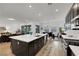 Open kitchen with dark cabinets, a large center island and stainless steel appliances at 712 Webber Park St, Henderson, NV 89011