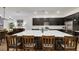 Open concept kitchen boasts large island with seating, dark cabinets, and stainless appliances at 712 Webber Park St, Henderson, NV 89011