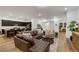 Open-concept living space with kitchen island, leather sofa, and neutral decor at 712 Webber Park St, Henderson, NV 89011