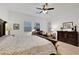 Bright, airy main bedroom featuring a ceiling fan, large windows, and charming décor at 712 Webber Park St, Henderson, NV 89011