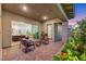 Relaxing covered patio with outdoor seating, sliding glass doors, and garden views at 712 Webber Park St, Henderson, NV 89011